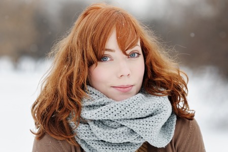 Outdoors portrait of young beautiful woman in winter