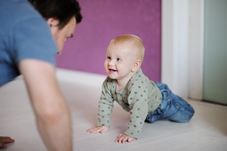 Little baby boy playing with his father at homeの写真素材