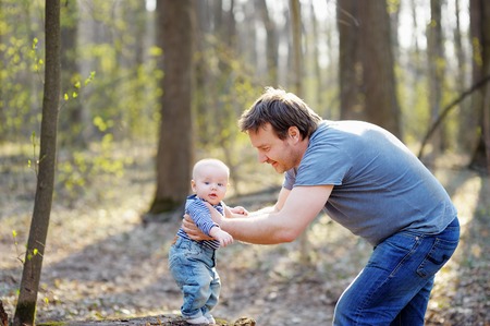 Father with his little baby boy in a forestの写真素材