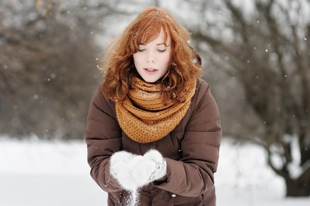 Young beautiful woman having fun in winterの写真素材