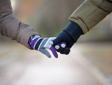 Detailed view of a young couple holding handsの写真素材