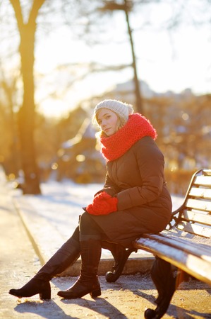 Outdoors portrait of young beautiful woman in the winter at sunsetの写真素材