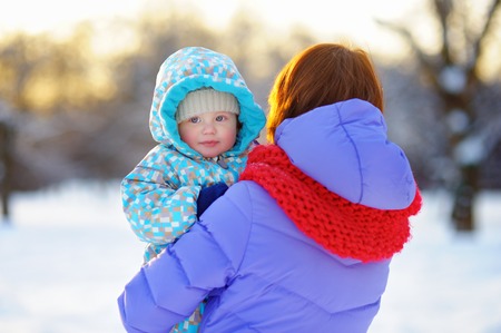 Outdoors portrait of young woman with her little baby boyの写真素材