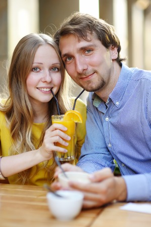Happy young couple in the outdoor cafeの写真素材