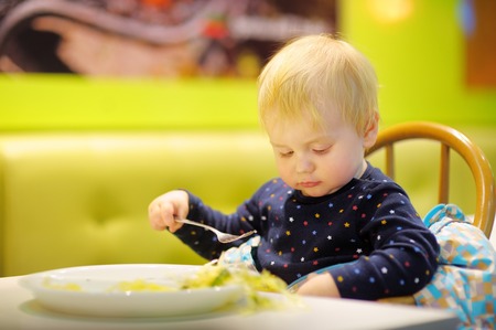 Toddler boy at the indoors cafeの写真素材