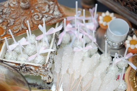 Sugar on sticks and pink pop cakes on tea trayの写真素材