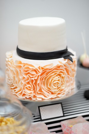 Delicious white wedding cake decorated with cream roses