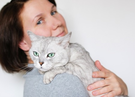 Middle age woman holding beautiful grey catの写真素材