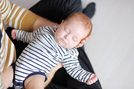 Young father holding his sweet little newborn babyの写真素材