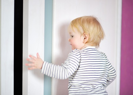 Blonde toddler boy playing at home