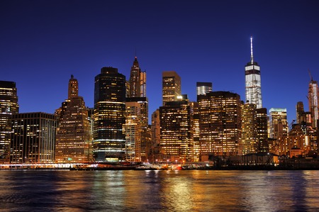 New York City Manhattan downtown skyline at night with illuminated skyscrapersの写真素材