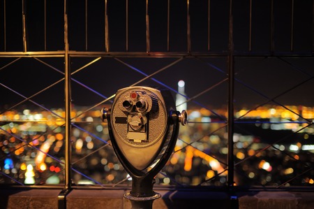Binoculars looking down to the New York City at nightの写真素材