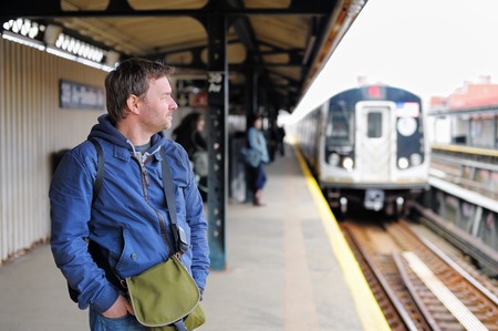Middle age man waiting train in NYC subway