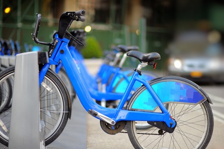 Row of city bikes for rent at docking stations in New York, USA