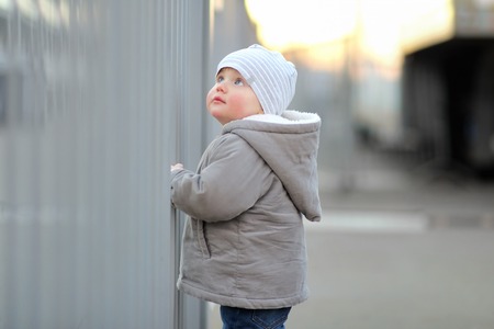 Portrait of toddler boy walking in a big cityの写真素材