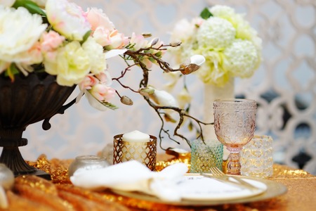 Stylish gold table set with natural flowersの写真素材