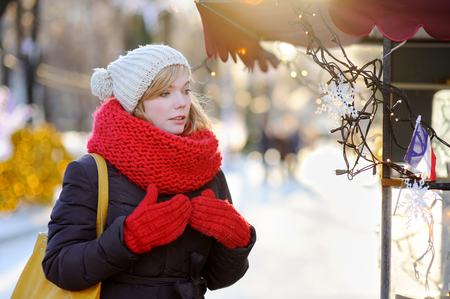 Outdoors portrait of young beautiful woman at winter cityの写真素材