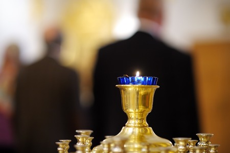 Close up photo of ablaze candle during church serviceの写真素材