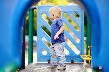 Cute toddler boy having fun on outdoors playgroundの写真素材