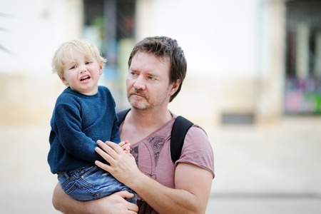 Middle age father with his little son walking outdoors. Fatherhood conceptの写真素材