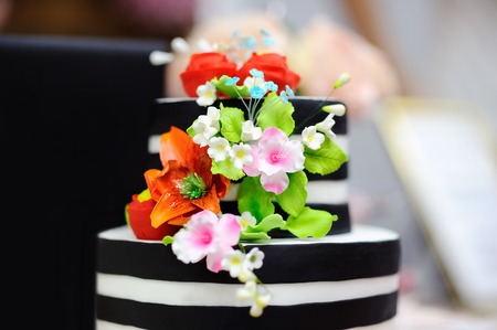 Gold wedding cake decorated with white sugar flowers. Sweet table on wedding partyの写真素材