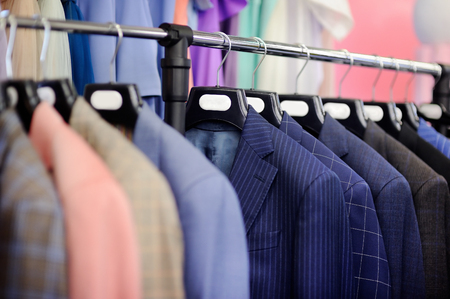 Beautiful wedding suits with tie and handkerchief on a hangerの写真素材