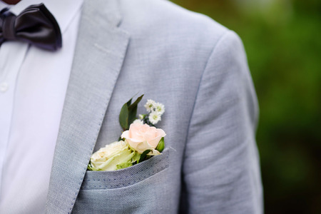 Boutonniere groom made of fresh white roseの写真素材