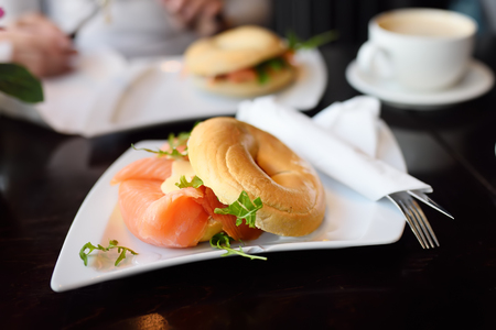 Freshly baked bagel with smoked salmon, cream cheese and arugula. Healthy foods.の写真素材