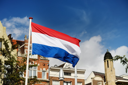 Netherlands flag waving in the blue skyの写真素材