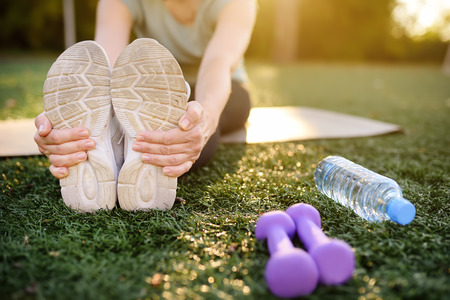 Mature woman practicing yoga outdoor exercise or doing fitness. Healthy lifestyle.