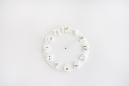 White clock on the white wall. Apartment interiors detail. Minimalism.の写真素材