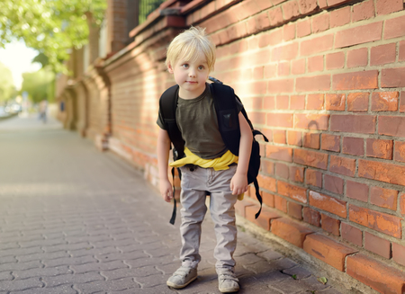 Student with large backpack near the school building. Back to school. Education.の写真素材