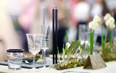 Table set for an event party or wedding reception in rustic or scandinavian style. Fashionable table...
