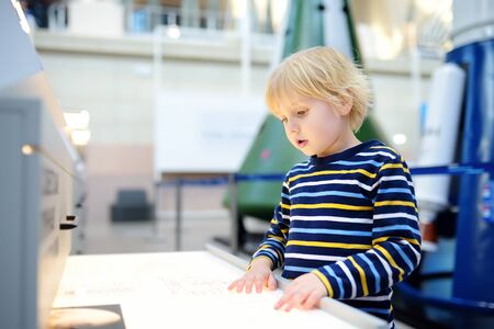 Little ?aucasian boy is looking an exposition in a scientific museum. Education and entertainment for children. Activities for family with preschooler kids.の写真素材