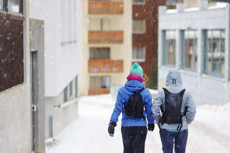 Tourists walking on street of mountain resort town in Switzerland, Europe. Winter vacation concept...