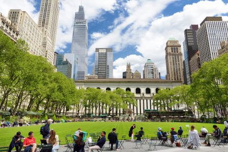 New York, USA - May 11, 2021: People are relaxing and enjoying nice sunny spring day in Bryant Park...