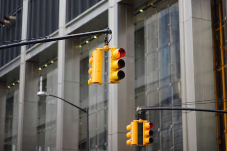Yellow Traffic Light on background of skyscrapers, Manhattan, New York, USA. Red stop signal. Yellow Traffic Light is one of a characteristic feature of nyc.の写真素材