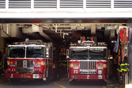 New York, USA - May 09, 2021: A fire station with two fire trucks ready to leave immediately to extinguish the fire in Midtown of New York Cityのeditorial素材