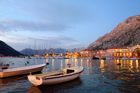 Picturesque Kotor bay at blue hour. Wonderful boats on te seascape backgrond of coast of Adriatic sea. Travel and tourism in Montenegro.の写真素材