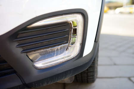 Broken headlight automobile close-up. Destroyed front light on the left side. car crash or accident....