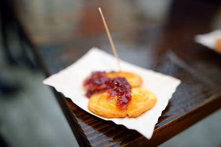 A portion of oscypek on Christmas market in Krakow. Oscypki - traditional Poland street food is a...