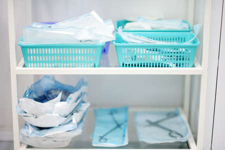 Table with sterile instruments in the operating room or doctor's office. Medical tools in disposable packages are ready for useの写真素材