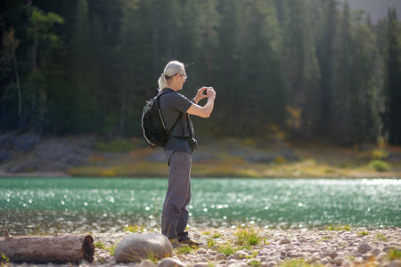 Gray haired mature man traveling in the National Park Durmitor, Montenegro. Senior tourist is taking...