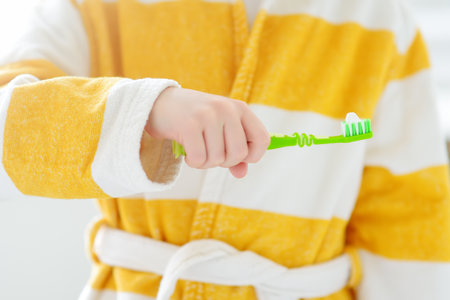 Cute child brushing teeth. Preschooler boy using toothpaste and toothbrush in bathroom during morning routine. Baby learning brush tooth. Equipments for kids dental and oral hygiene. healthcare.の写真素材