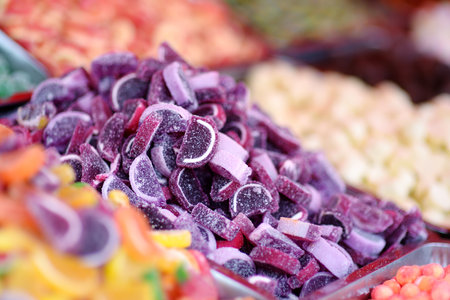 A lot of colors gummy, jelly, toffee, fudge, caramel and chocolate candies are selling in shop. Assortment of multicolored sweets as a food background. Colorful texture. Close-up.の写真素材