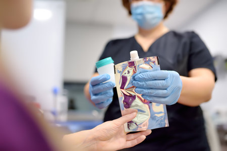 A nurse in the laboratory offers the patient a medical balloon to perform a test for Helicobacter. Modern technology for diagnosis of helicobacter pylori bacterial infectionの写真素材