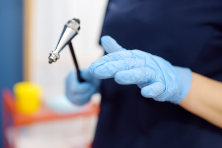 Doctor is checking the neurological reflexes of the patient with a hammer. Neurology professional doctor at work placeの写真素材