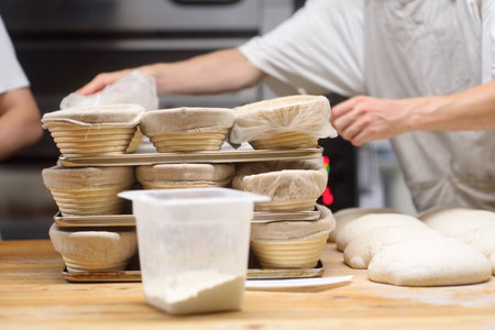 The bakery chef prepares the dough for baking bread to an old traditional recipe. Olive ciabatta...