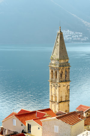 Picturesque view of Church Our Lady of the Rosary with mountains in the background. Tourist sights in Perast, Montenegro. Vertical bannerの写真素材