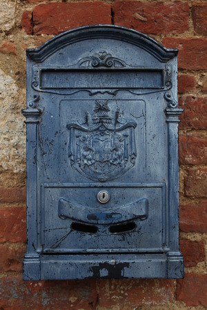 Blue mailbox on a brick wallの写真素材